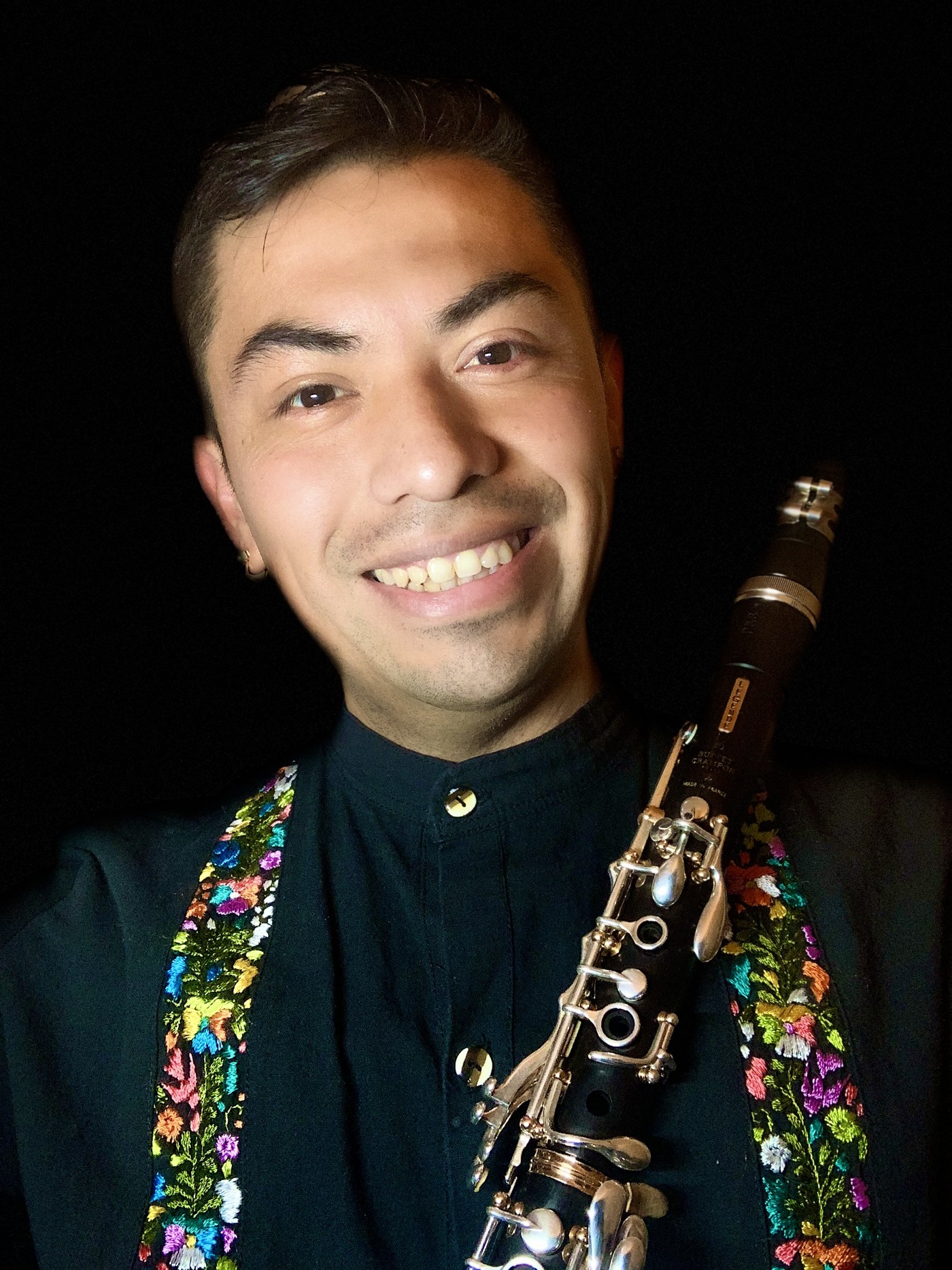 Carlos Herrera holding a clarinet